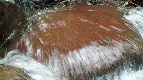 Brown River Water Flowing Over Rocks Natural Texture Close-Up Stock Footage 330541173