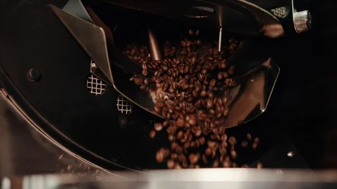 Brown roasted coffee beans are pouring from a metal container. Stock Footage 108101335