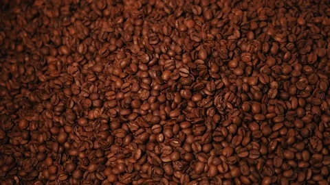 Brown roasted coffee beans are being mixed. Stock Footage 108102712