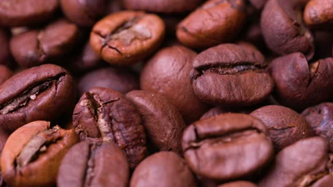 Brown roasted coffee beans. Coffee beans. Natural coffee seeds. Close-up. Stock Footage 148136176