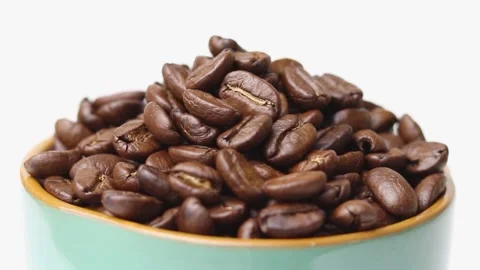 Brown roasted coffee beans on a rotating plate Stock Footage 169709770