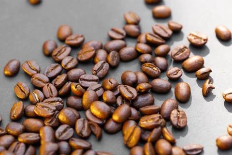 Brown roasted coffee beans seed on dark background Stock Photos