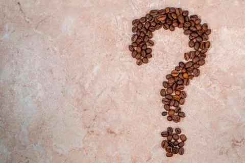Brown roasted coffee beans in the shape of a question mark Stock Photos