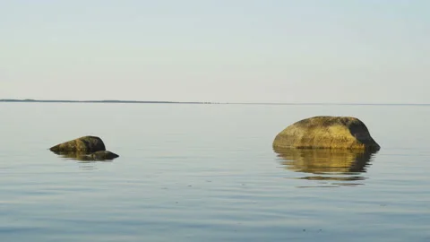 The brown rocks on the waters in the beach Stock Footage 139664654