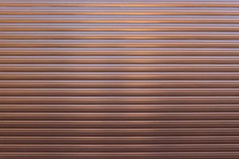 Brown roller shutter door or curtain. Grunge brown metal foldable door Stock Photos