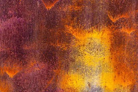 Brown rusted sheet metal surface with white spray paint remnants Фото