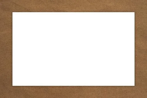 Brown rustic fabric background with white rectangle for text. Textured backgr Stock Photos