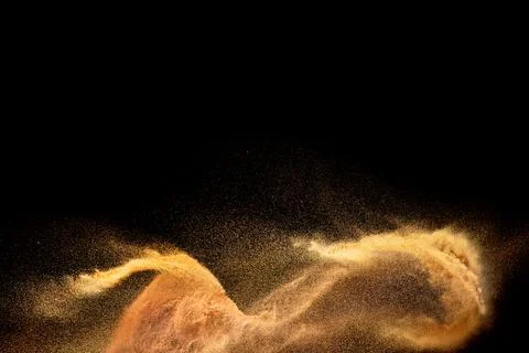 Brown sand explosion isolated on black background. Freeze motion of sandy d.. Stock Photos