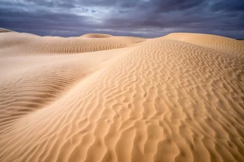 Brown sand under white clouds during daytime Stock Photos