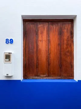 Brown simplistic closed window in the old medina of Asilah Stock Photos