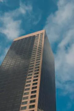 Brown Skyscraper Leading Up to the Clouds Stock Photos