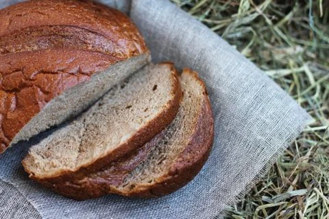 Brown sliced bread on hay Stock Photos
