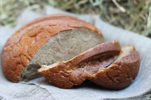 Brown sliced bread on hay Stock Photos