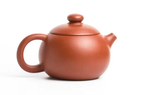 Brown small earthenware teapot isolated on white background Stock Photos