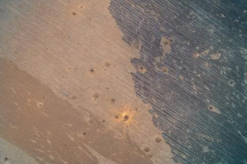 Brown soil texture and dark plowed earth patterns with small mounds on 스톡 사진