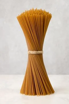 Brown spaghetti in a bunch on gray background Stock Photos