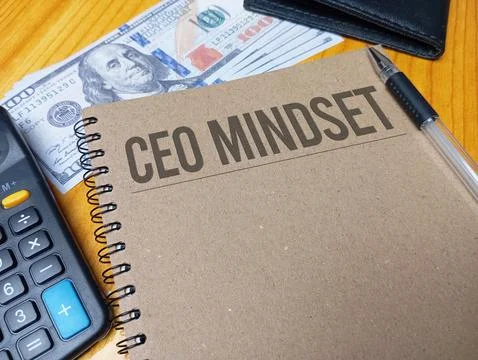 Brown spiral notebook with CEO Mindset text on a wooden desk with a calcula.. Stock Photos