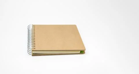 Brown spiral notebook lying on white background Stock Photos