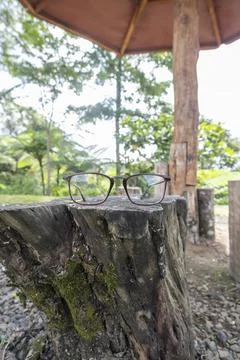 Brown square eyeglass frame on old wood. square eyeglass frame in the photo f Stock Photos