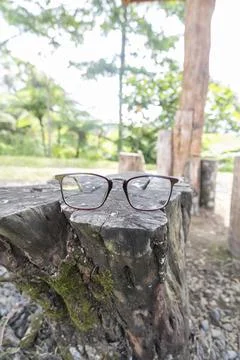 Brown square eyeglass frame on old wood. square eyeglass frame in the photo f Stock Photos