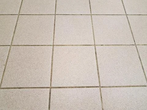 Brown square kitchen tiles on the floor Stock Photos