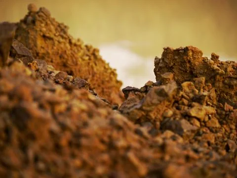 Brown stone rocks texture behind dirty water river presented on background bl 스톡 사진