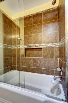Brown stone tile shower with close up in the bathroom Stock Photos