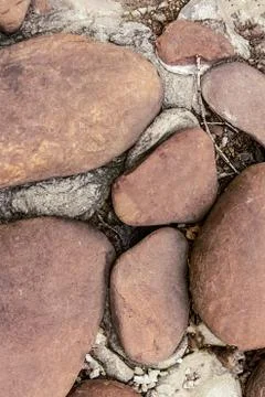 Brown stone vertical background close up. background cobblestone pebble brown Stock Photos