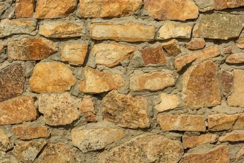 Brown stone wall. Background Stock Photos