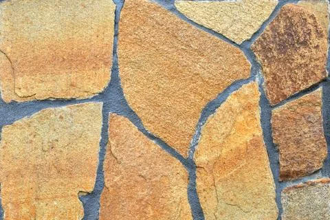 Brown stone wall, background, texture, rectangular natural stones of differen Stock Photos