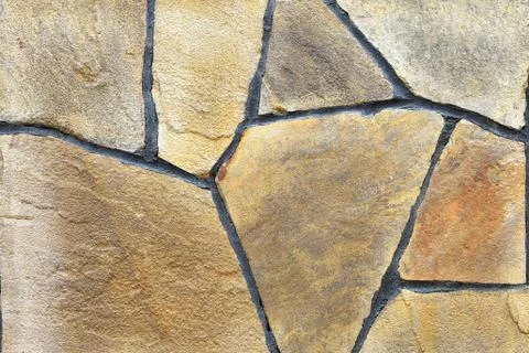 Brown stone wall, background, texture, rectangular natural stones of differen Stock Photos