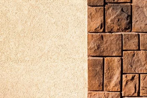 Brown stone wall with plaster Foto stock