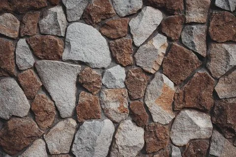 Brown stone wall texture background .  Old castle stone wall texture . Stock Photos