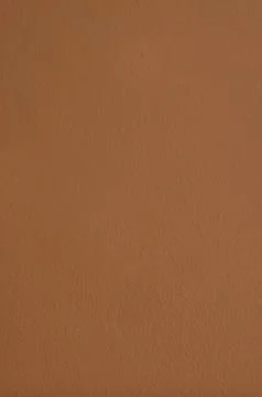 Brown structural painted wallpaper on the wall Stock Photos