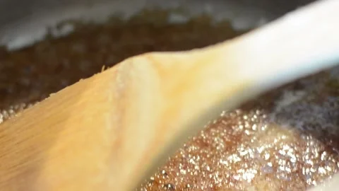 Brown Sugar and Butter boiling in a heated pan Stock Footage 130356589