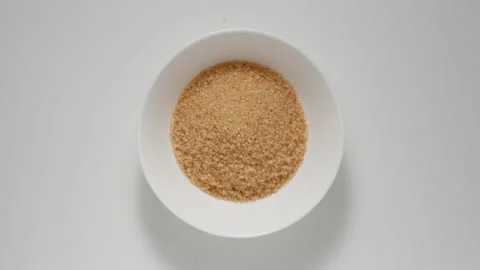 Brown sugar appear in deep dish, stop motion Stock Footage 146370285