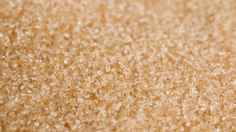 Brown sugar crystals, close-up, representing raw food material, sugar red Stock Footage 328254306