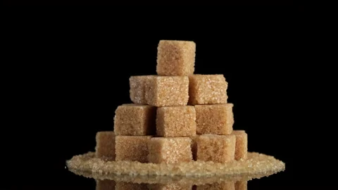 Brown sugar cubes on black background rotating. Demerara golden brown sugar Stock-Footage 147732745
