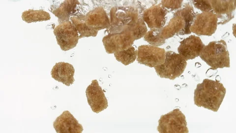 Brown Sugar Cubes Falling into Water in Slow Motion on White Background Isolated Stock Footage 171922098