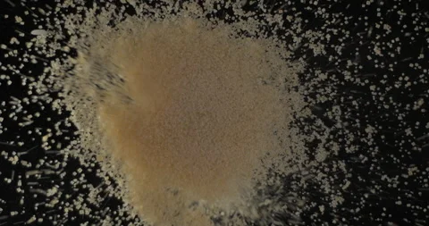 Brown sugar falling from below, slowmotion low angle 4K pro res Stock Footage 275897954
