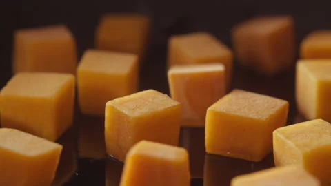 Brown sugar falling on pumpkin cubes Stock Footage 135061573