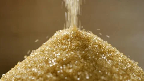 Brown sugar falling in slow motion, close-up Stock Footage 115631345