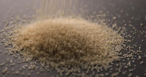 Brown sugar pouring slow motion in studio 4K pro res Video stock 273635834