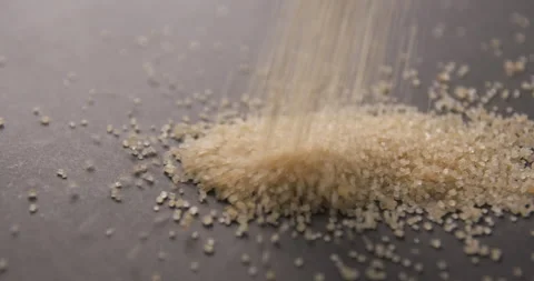 Brown sugar pouring slow motion in studio 4K pro res Video stock 273635969