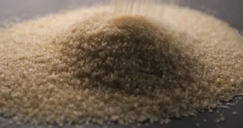 Brown sugar pouring slow motion in studio 4K pro res Video stock 273636001
