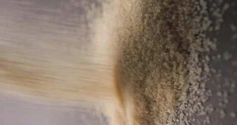 Brown sugar pouring slow motion in studio 4K pro res vertical Video stock 273636103
