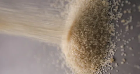 Brown sugar pouring slow motion in studio 4K pro res vertical Video stock 273636232