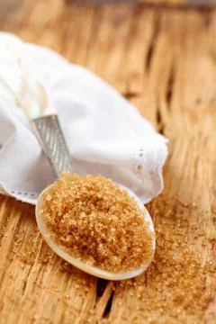 Brown sugar in spoon. Stock Photos