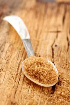 Brown sugar in spoon. Stock Photos