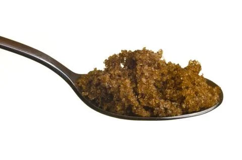Brown sugar in a spoon Stock Photos